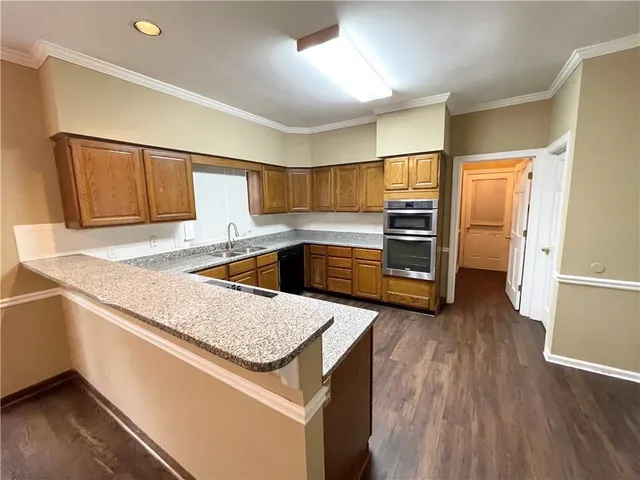 a kitchen with granite countertop a sink and a refrigerator