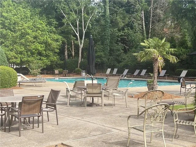 a view of a patio with table and chairs and potted plants