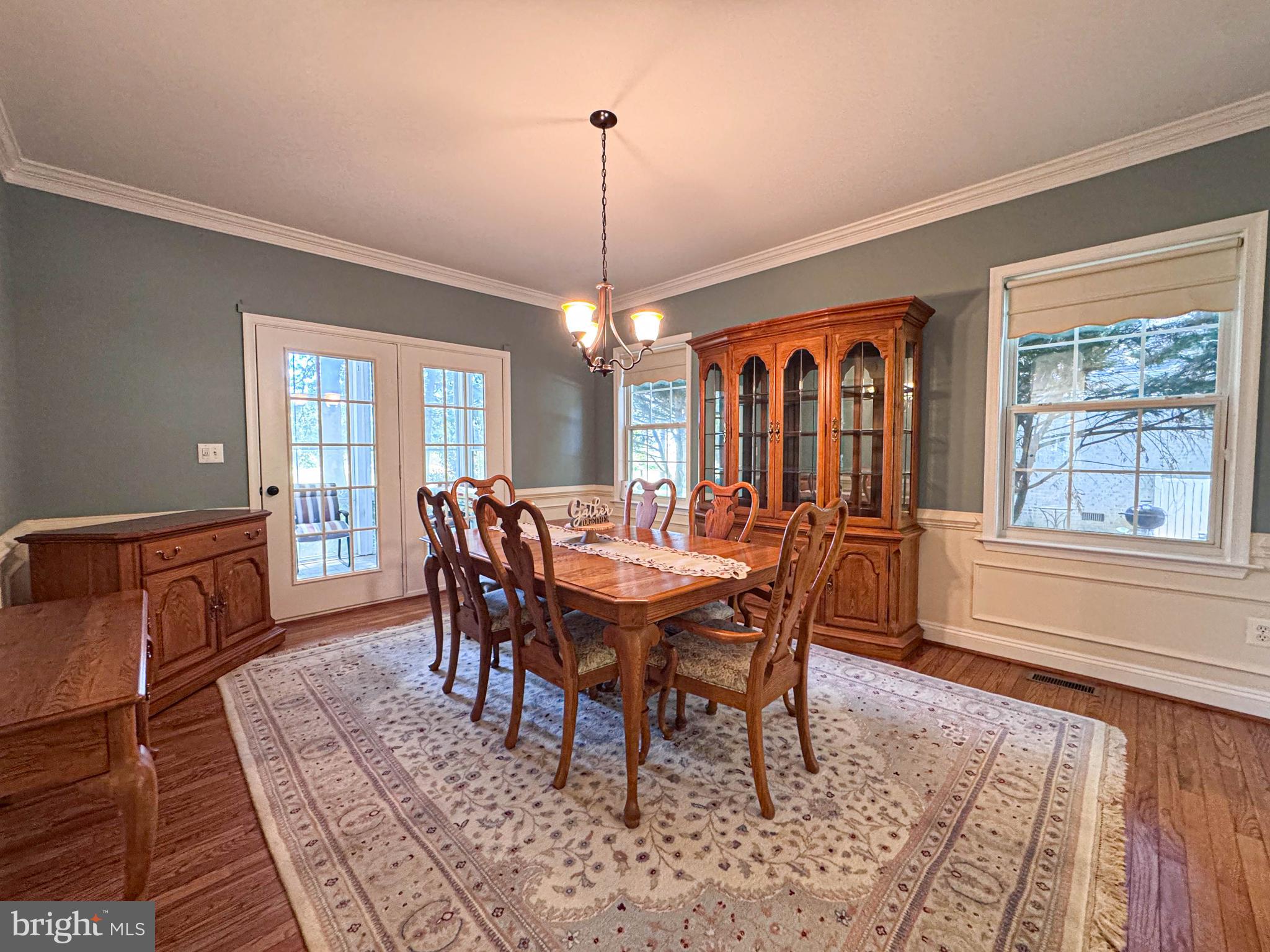 11325 Ingels Court Swan Point, MD 20645 - Photo 22 of 118 a dining room with furniture a chandelier and wooden floor