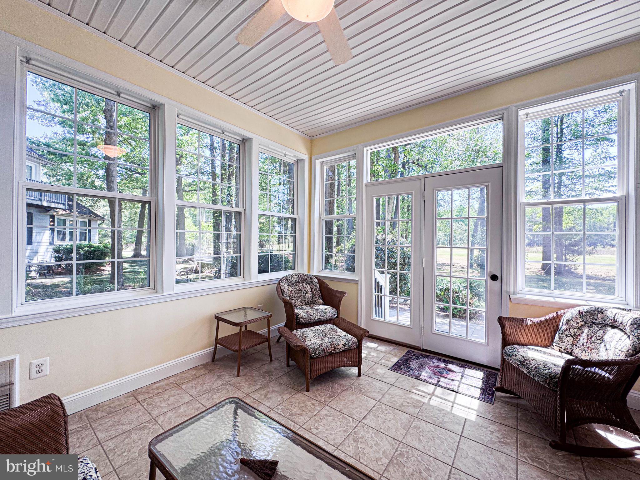 11325 Ingels Court Swan Point, MD 20645 - Photo 38 of 118 a living room with furniture and floor to ceiling windows