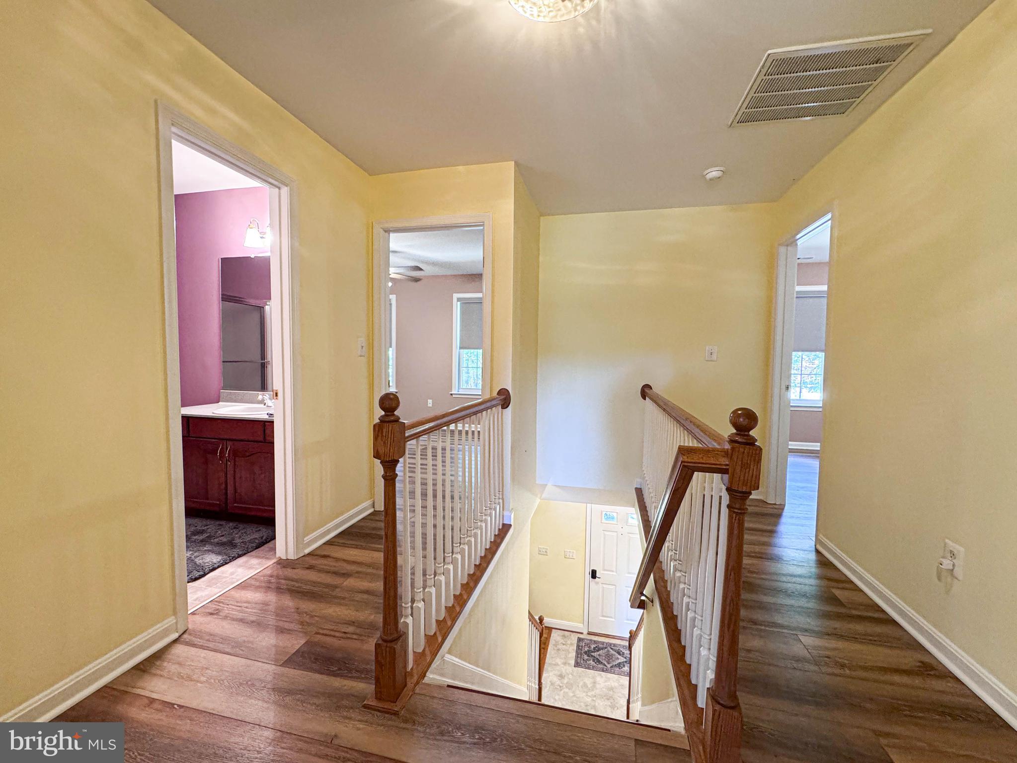 11325 Ingels Court Swan Point, MD 20645 - Photo 65 of 118 a view of a hallway with wooden floor and stairs