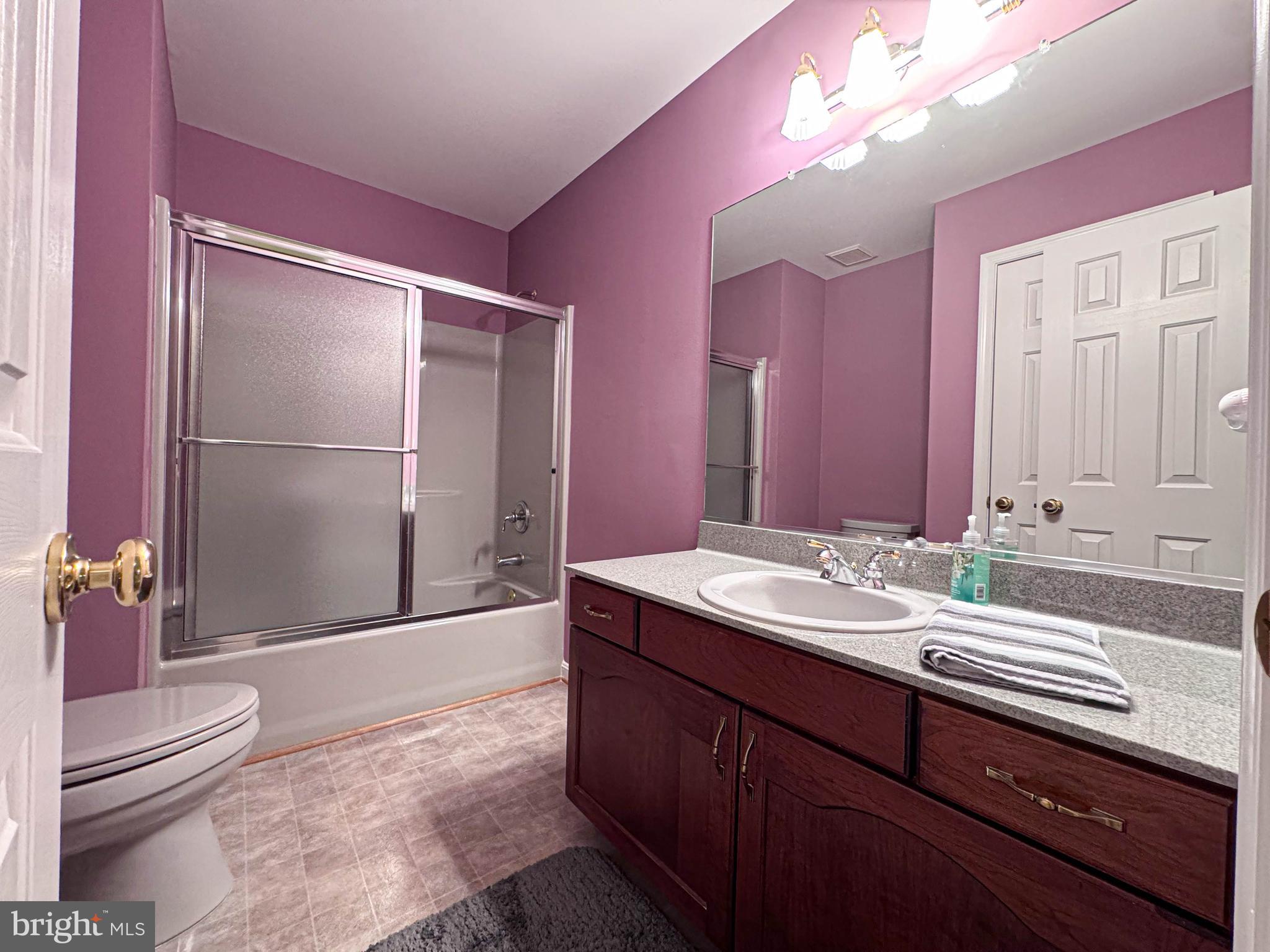 11325 Ingels Court Swan Point, MD 20645 - Photo 67 of 118 a bathroom with a sink a toilet and a large mirror