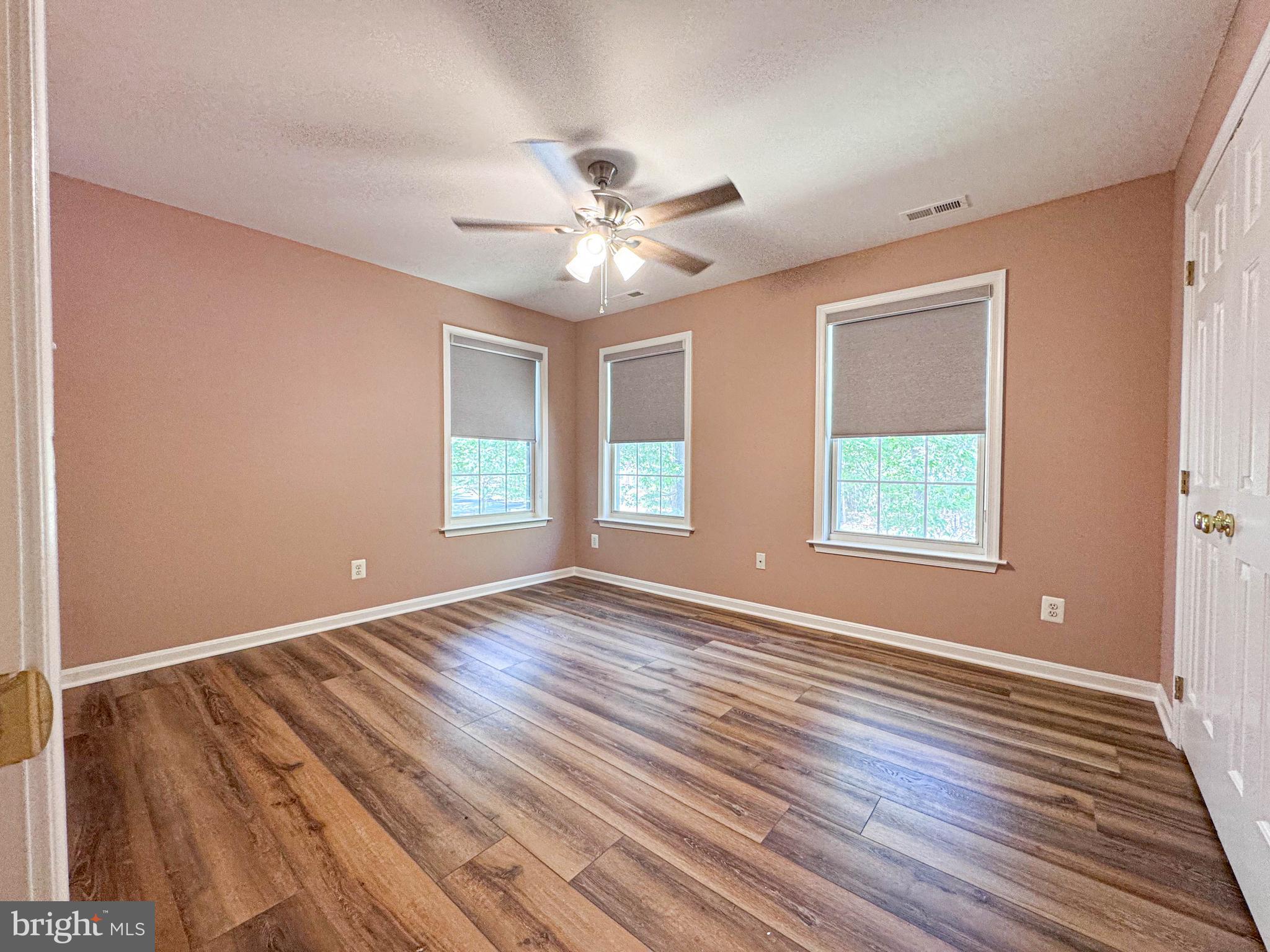 11325 Ingels Court Swan Point, MD 20645 - Photo 70 of 118 a view of an empty room with window and wooden floor