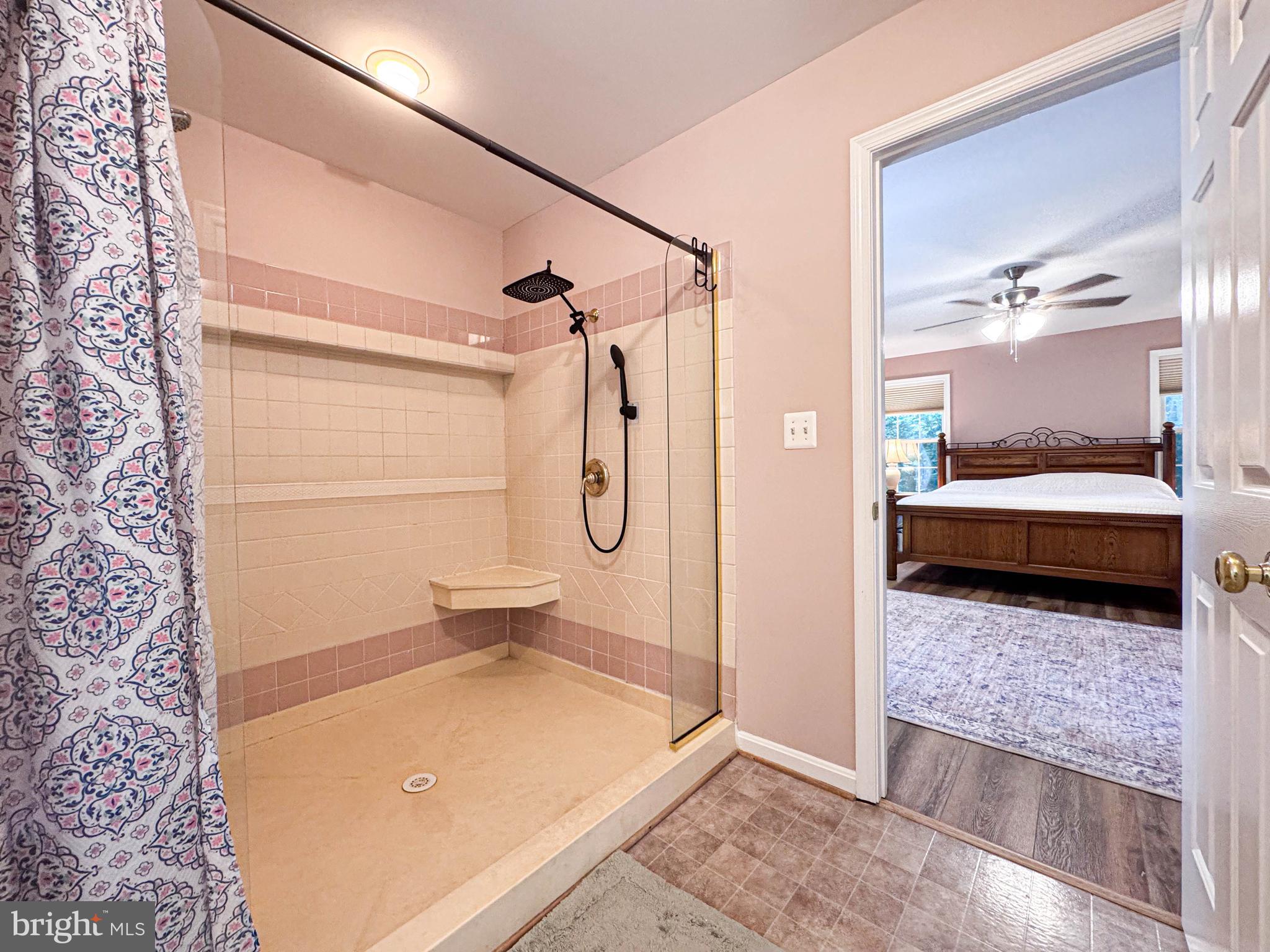 11325 Ingels Court Swan Point, MD 20645 - Photo 88 of 118 a bedroom with a bed and a glass door shower