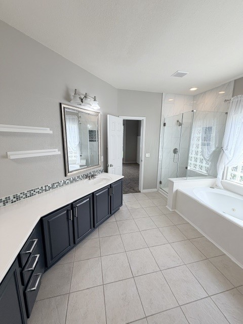 20030 Castlegreen Drive Spring, TX 77388 - Photo 13 of 23 a spacious bathroom with a double vanity sink mirror and bathtub