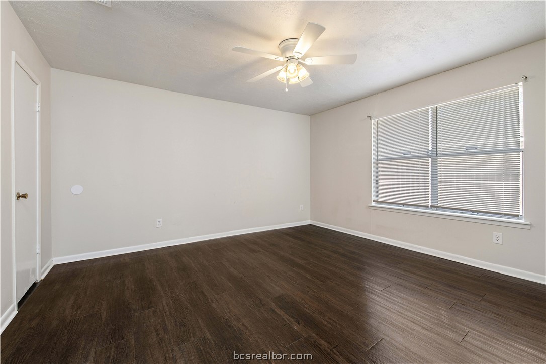 4403 Robinhood Circle Bryan, TX 77803 - Photo 11 of 19 an empty room with wooden floor and windows