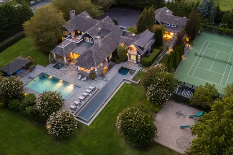 an aerial view of residential houses with outdoor space and street view