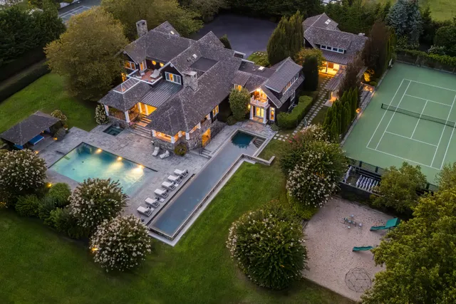 an aerial view of residential houses with outdoor space and street view