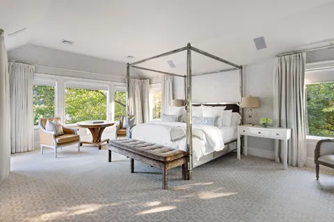 a spacious bedroom with a bed and large window