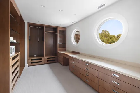 a room with painting on the wall and a window