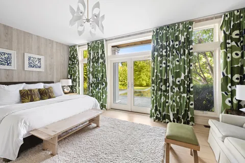 a bedroom with a bed and a chair