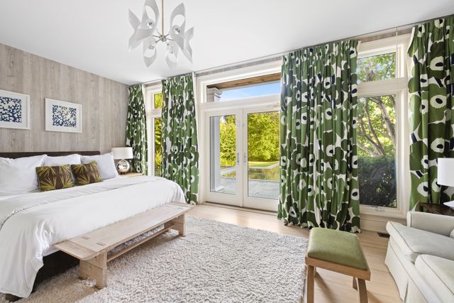 a bedroom with a bed and a chair