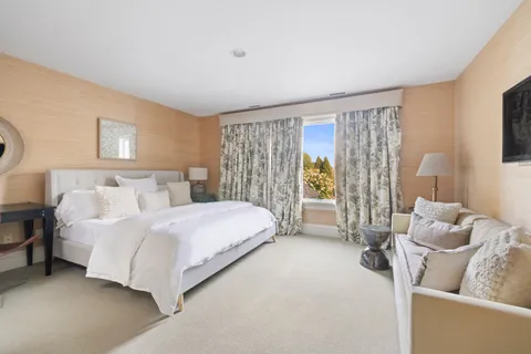 a spacious bedroom with a bed and a couch