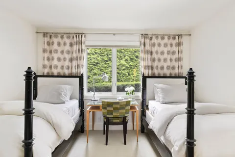 a bedroom with a bed and a night stand