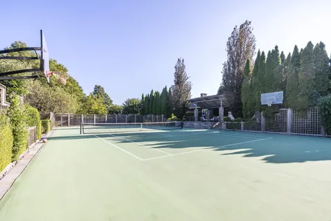 a roof deck with couches and wooden floor