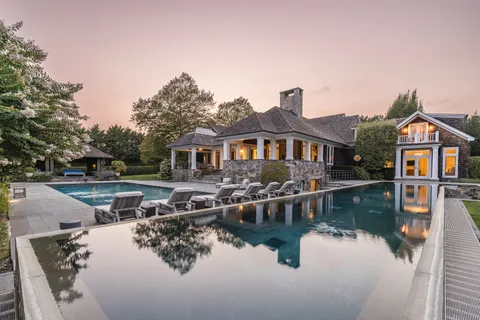 a view of a house with pool and a yard