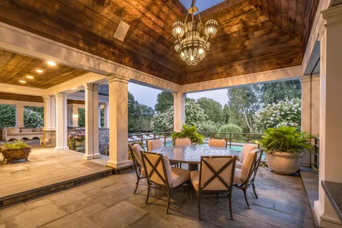a view of a patio with table and chairs and potted plants