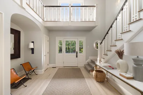 a view of entryway and hall with wooden floor