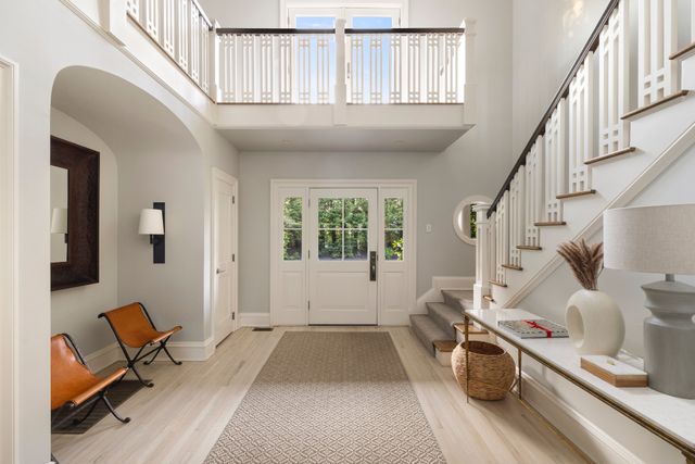 a view of entryway and hall with wooden floor