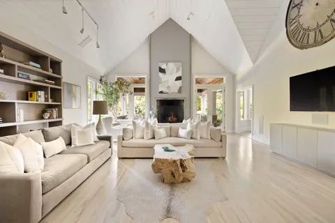 a living room with furniture fireplace and flat screen tv