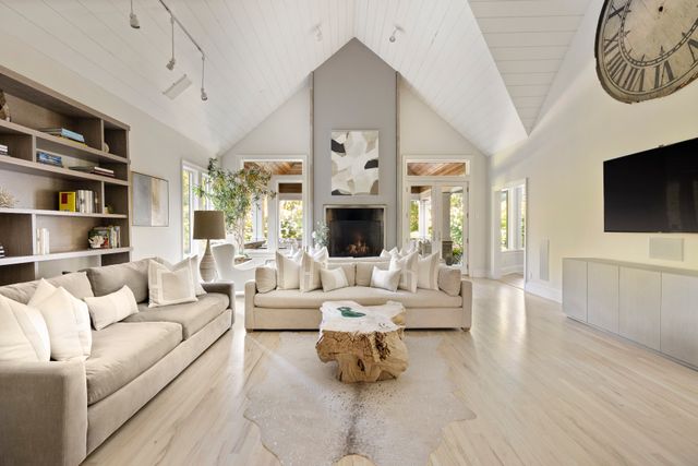 a living room with furniture fireplace and flat screen tv