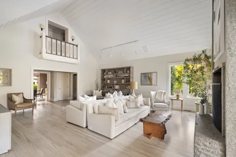 a living room with fireplace furniture and a wooden floor