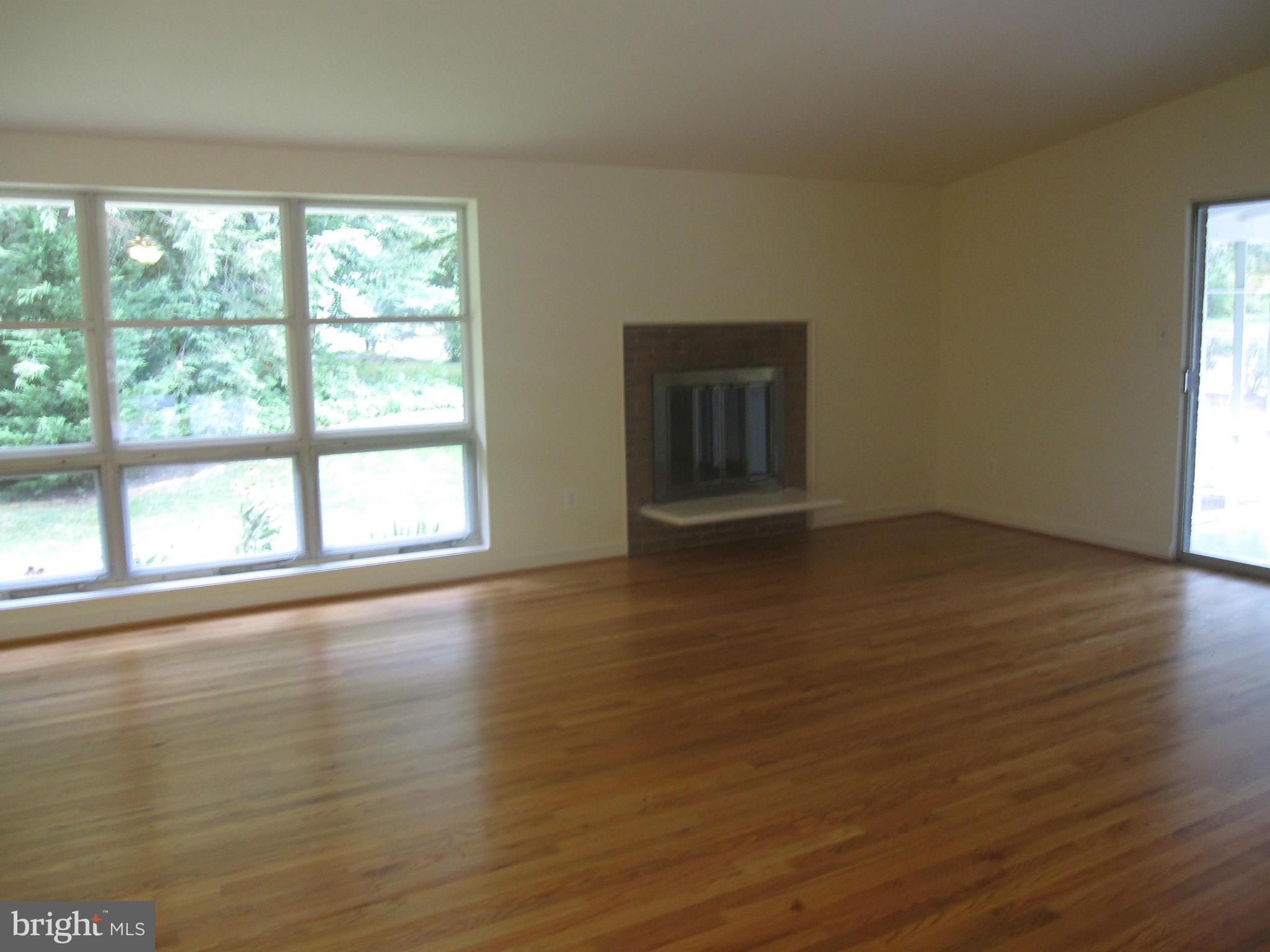 Living Room with fireplace and SGD to porch