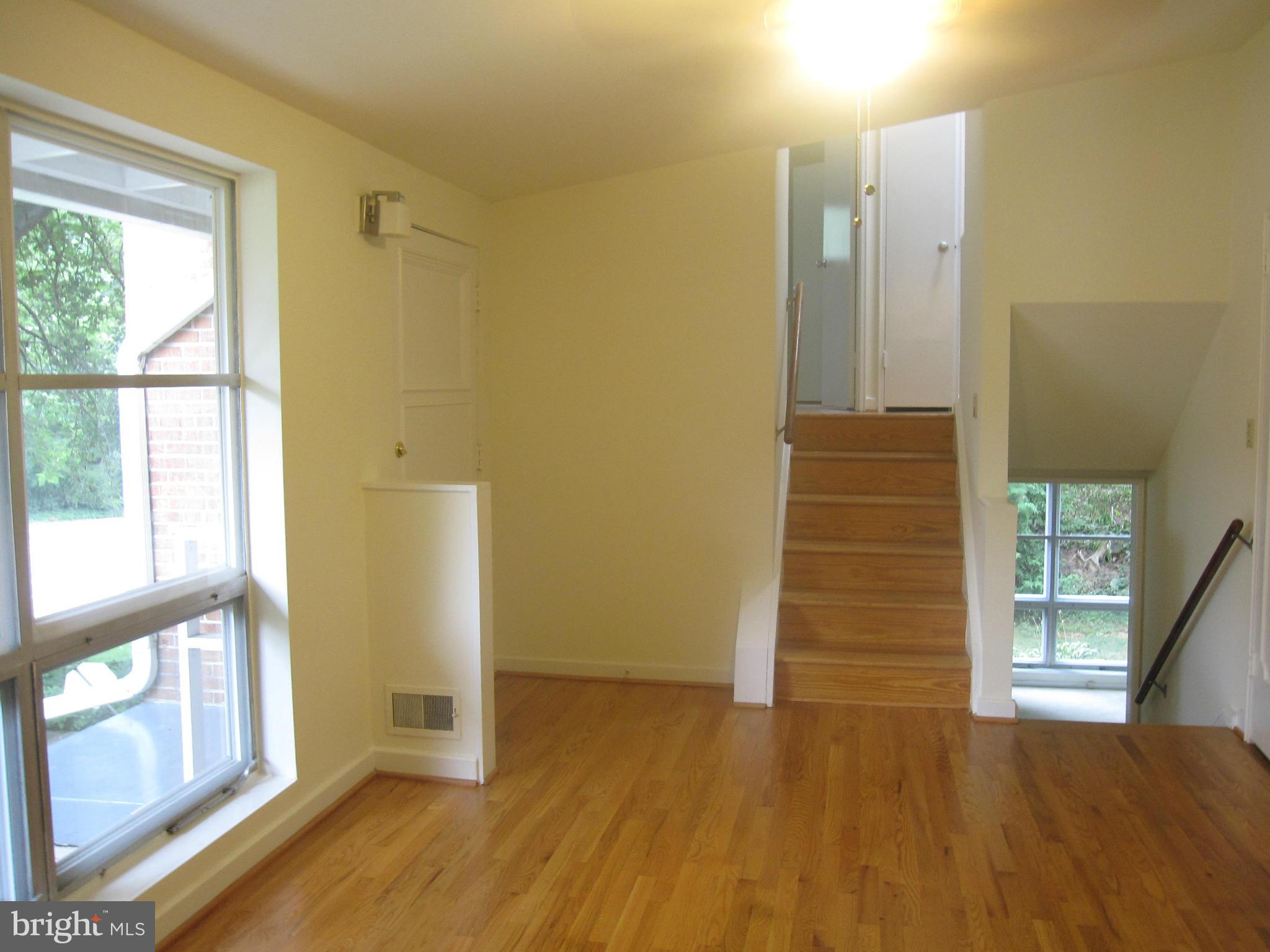 Front door with stairs to upper and lower levels