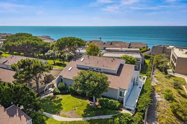 an aerial view of a house with a lake view