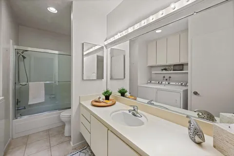 a bathroom with a sink double vanity and a shower