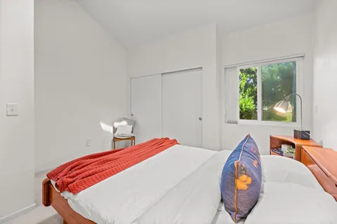 a bedroom with bed and a window