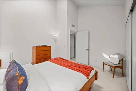 a bedroom with a bed and dresser