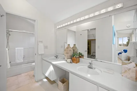 a bathroom with a sink double vanity and shower
