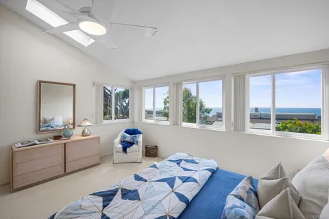 a living room with furniture and two large window