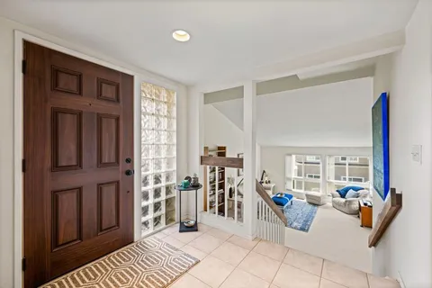 a view of a living room and a balcony