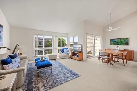 a living room with furniture and large windows