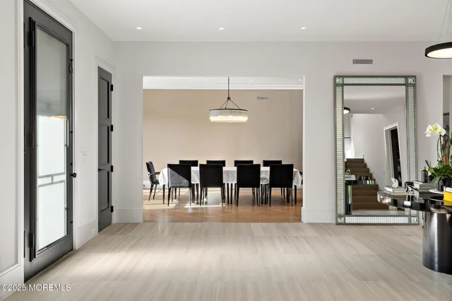 a living room with fireplace furniture and a large window