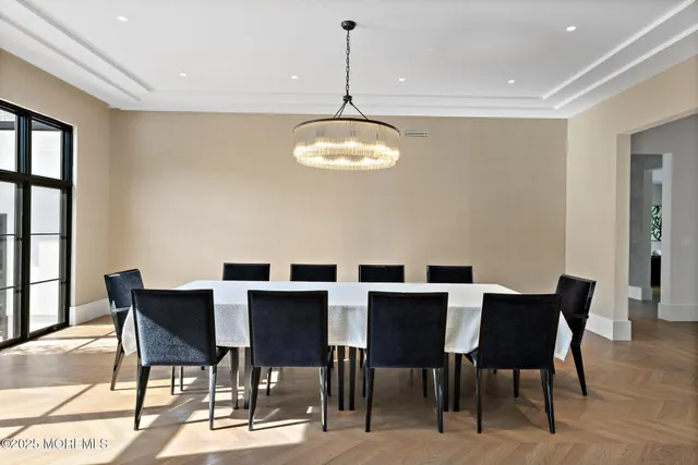 a view of a patio with couches table and chairs with plants and trees