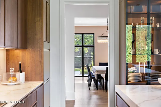 a living room with furniture kitchen view and a potted plant