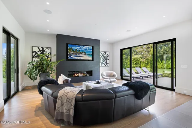 a view of a hallway with wooden floor and closet