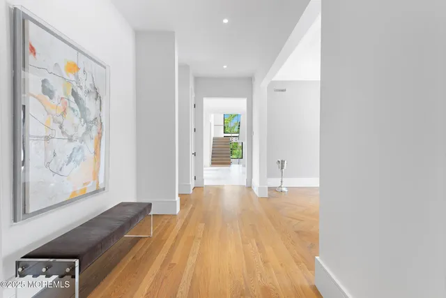 a front view of a house with a garden and trees