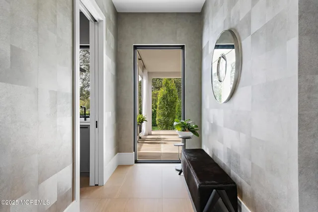 an aerial view of a residential houses with outdoor space and trees