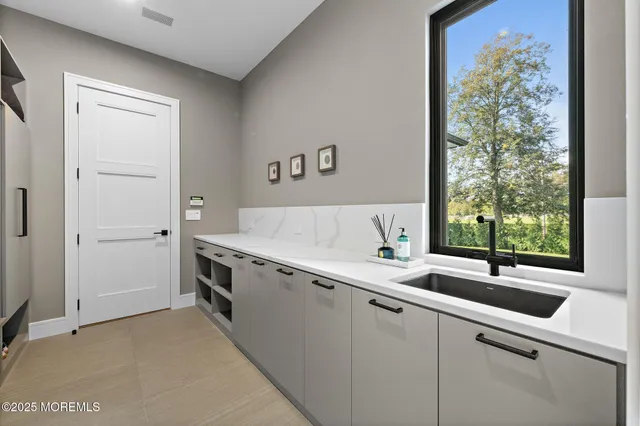 an aerial view of a city with lots of residential buildings lake and mountain view in back