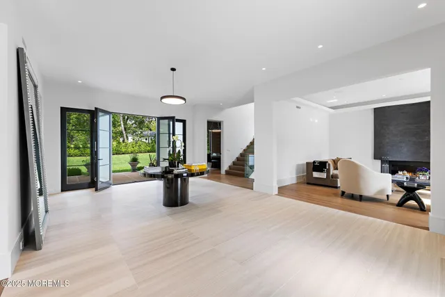 a kitchen with a table chairs and a large window