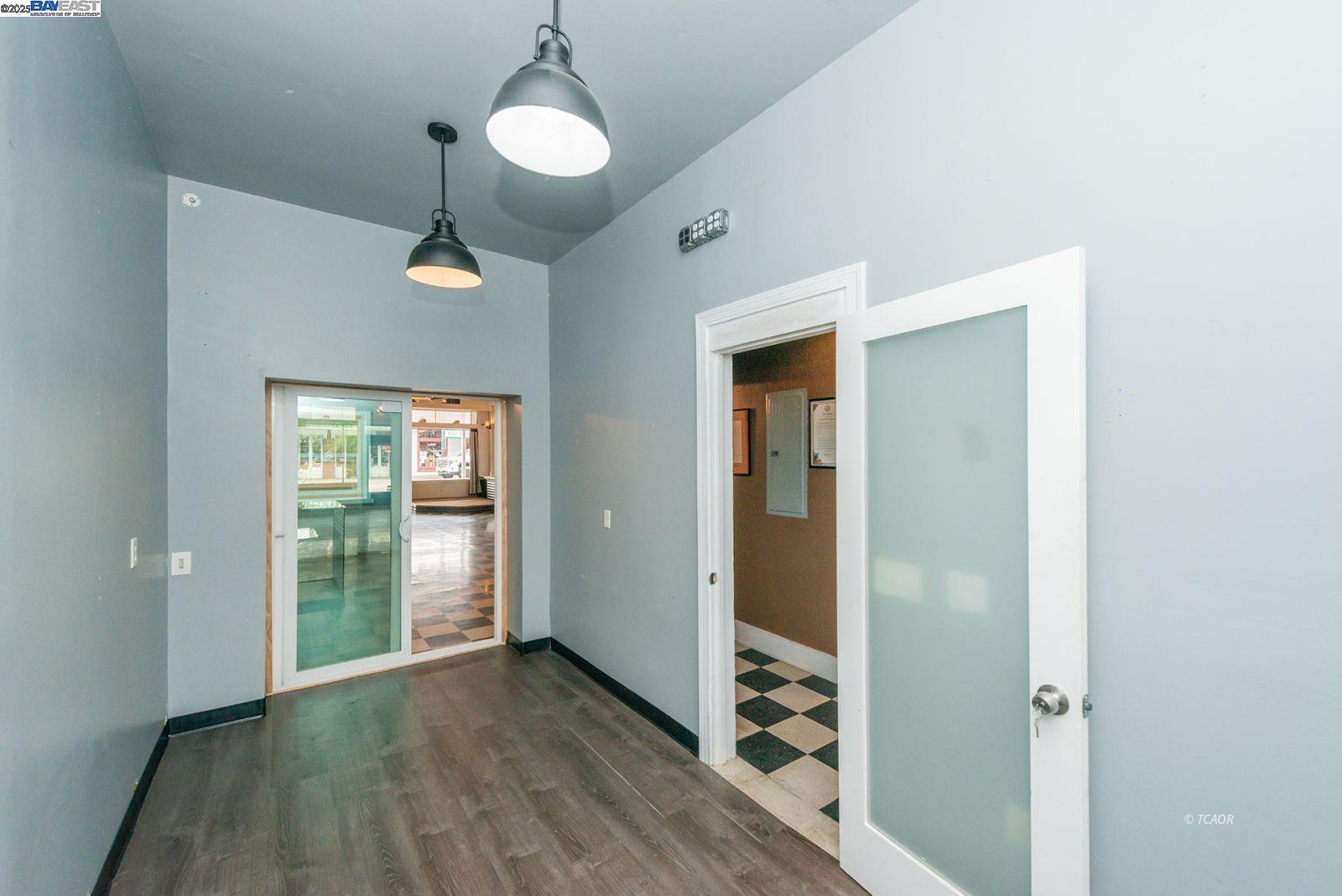 515 Main Street Weaverville, CA 96093 - Photo 5 of 36 a view of an empty room with wooden floor and a window