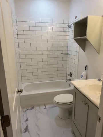 a bathroom with a toilet a sink and bathtub