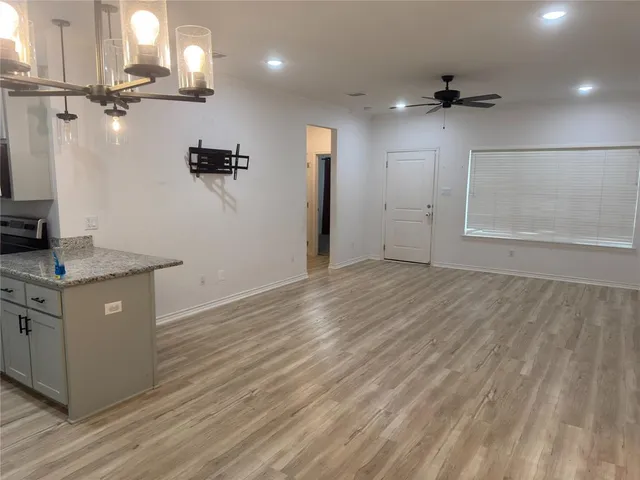 a view of a kitchen counter space and wooden floor