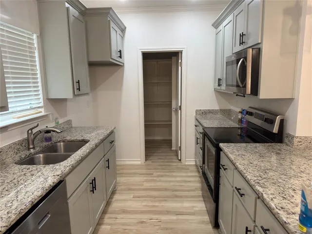 a kitchen with a stove and a sink