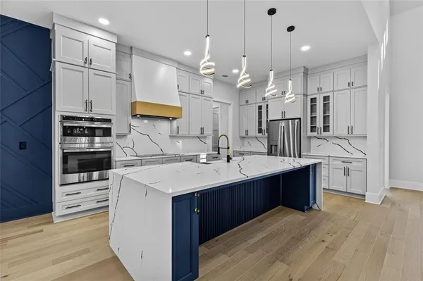 a kitchen with stainless steel appliances kitchen island a refrigerator and a stove