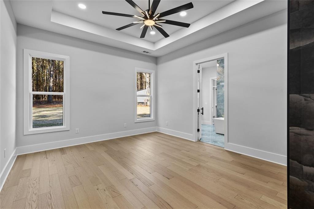 1198 Peters Cemetary Road Monroe, GA 30655 - Photo 21 of 64 a view of an empty room with wooden floor and a window
